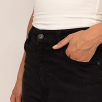 Woman wearing Marame Slim Leg Jeans in Black Wash Denim, detail.