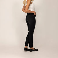 Woman wearing Marame Slim Leg Jeans in Black Wash Denim, rear view. |black wash denim
