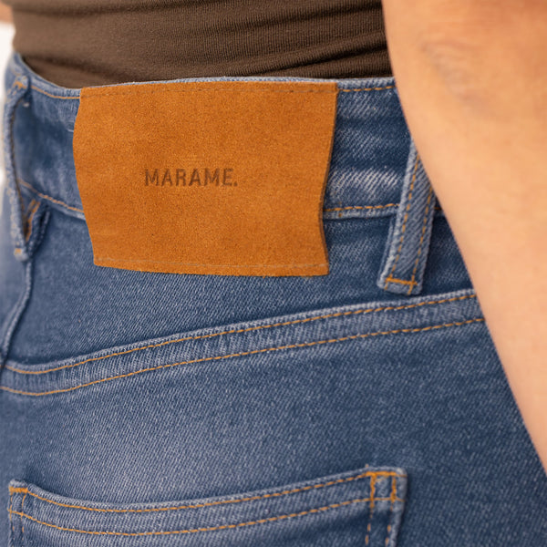 Woman wearing Slim Leg Jeans in Deep Navy Wash Denim, closeup.