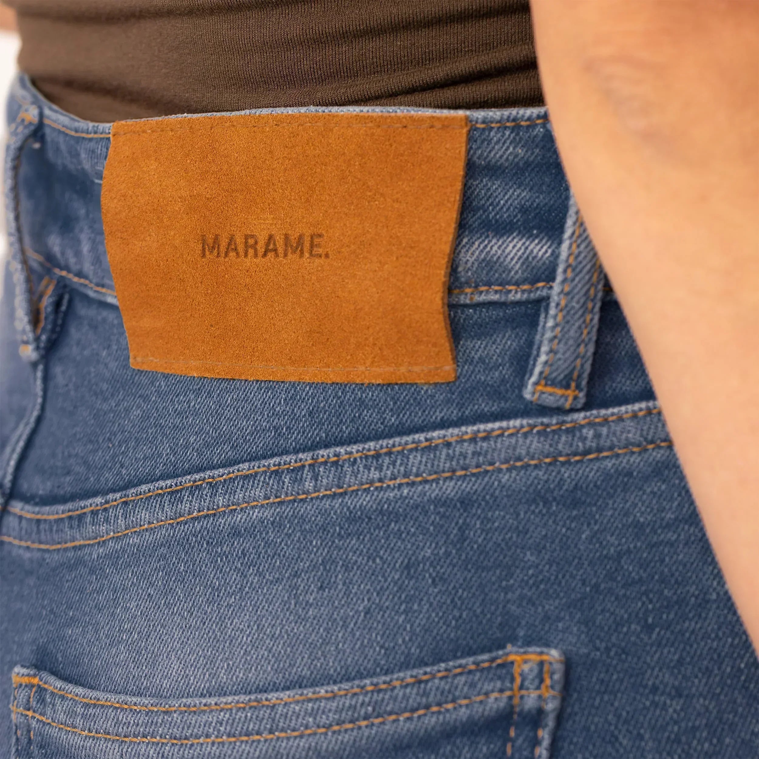 Woman wearing Slim Leg Jeans in Deep Navy Wash Denim, closeup. |deep navy wash denim