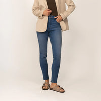 Woman wearing Marame Slim Leg Jeans in Deep Navy Wash Denim, front view.