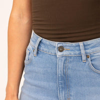 Woman wearing Slim Leg Jeans in Light Wash Denim, closeup.