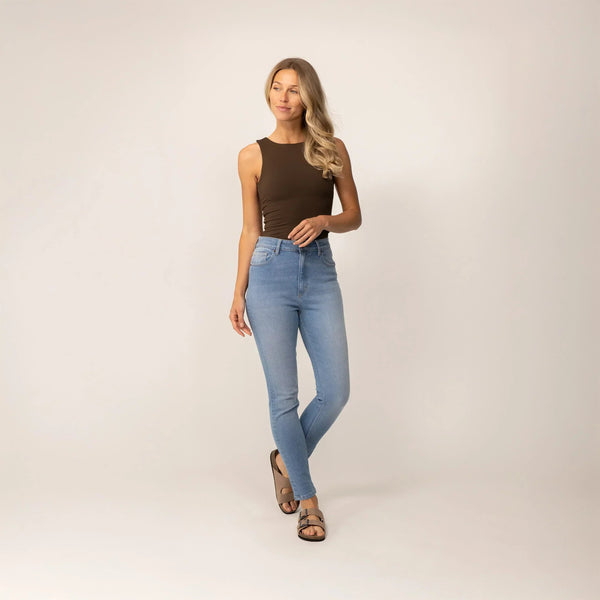 Woman wearing Marame Slim Leg Jeans in Light Wash Denim, full view. |light wash denim