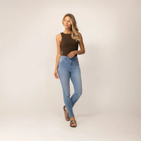Woman wearing Marame Slim Leg Jeans in Light Wash Denim, full view.