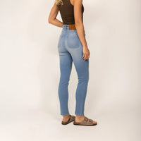Woman wearing Slim Leg Jeans in Light Wash Denim, rear view.