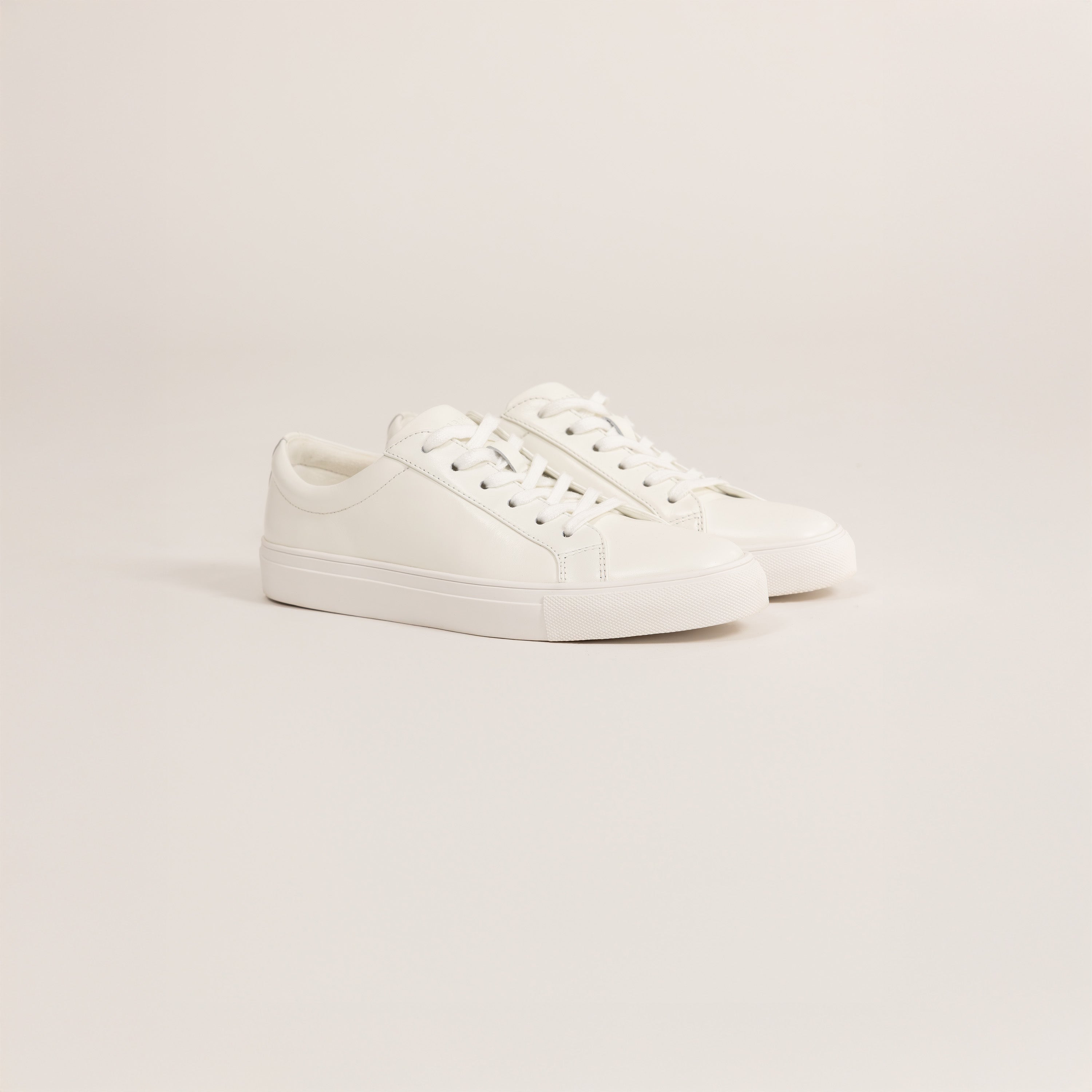 Woman wearing Marame Smart Leather Trainers in White, front view.