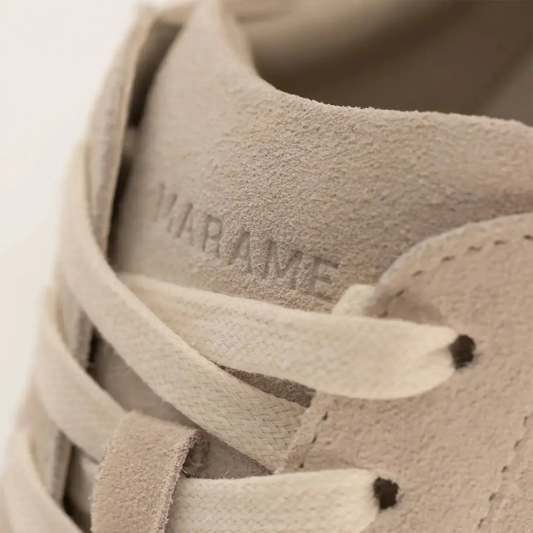 Woman wearing Marame Smart Suede Trainers in Grey, closeup.|grey