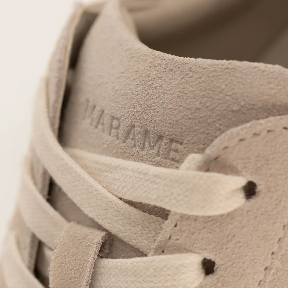 Woman wearing Marame Smart Suede Trainers in Grey, closeup.