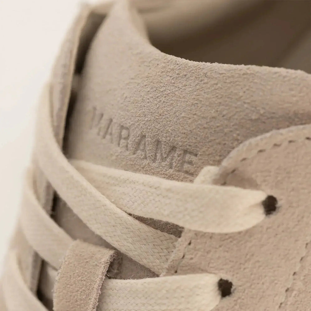 Woman wearing Marame Smart Suede Trainers in Grey, closeup.|grey