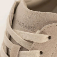 Woman wearing Marame Smart Suede Trainers in Grey, closeup.|grey