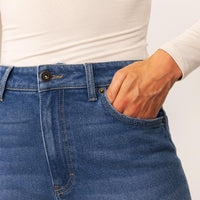 Woman wearing Marame Straight Leg Jeans in Deep Navy Wash Denim, closeup. |deep navy wash denim