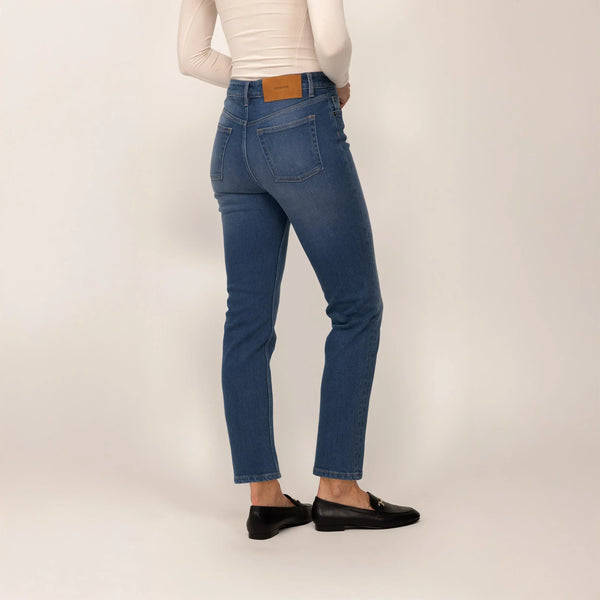 Woman wearing Marame Straight Leg Jeans in Deep Navy Wash Denim, rear view.