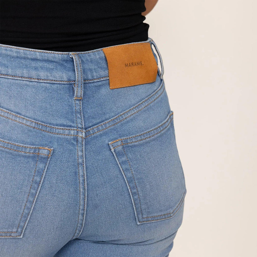 Woman wearing Marame Straight Leg Jeans in Light Wash Denim, closeup. |light wash denim