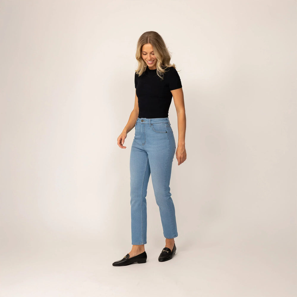 Woman wearing Marame Straight Leg Jeans in Light Wash Denim, front view.